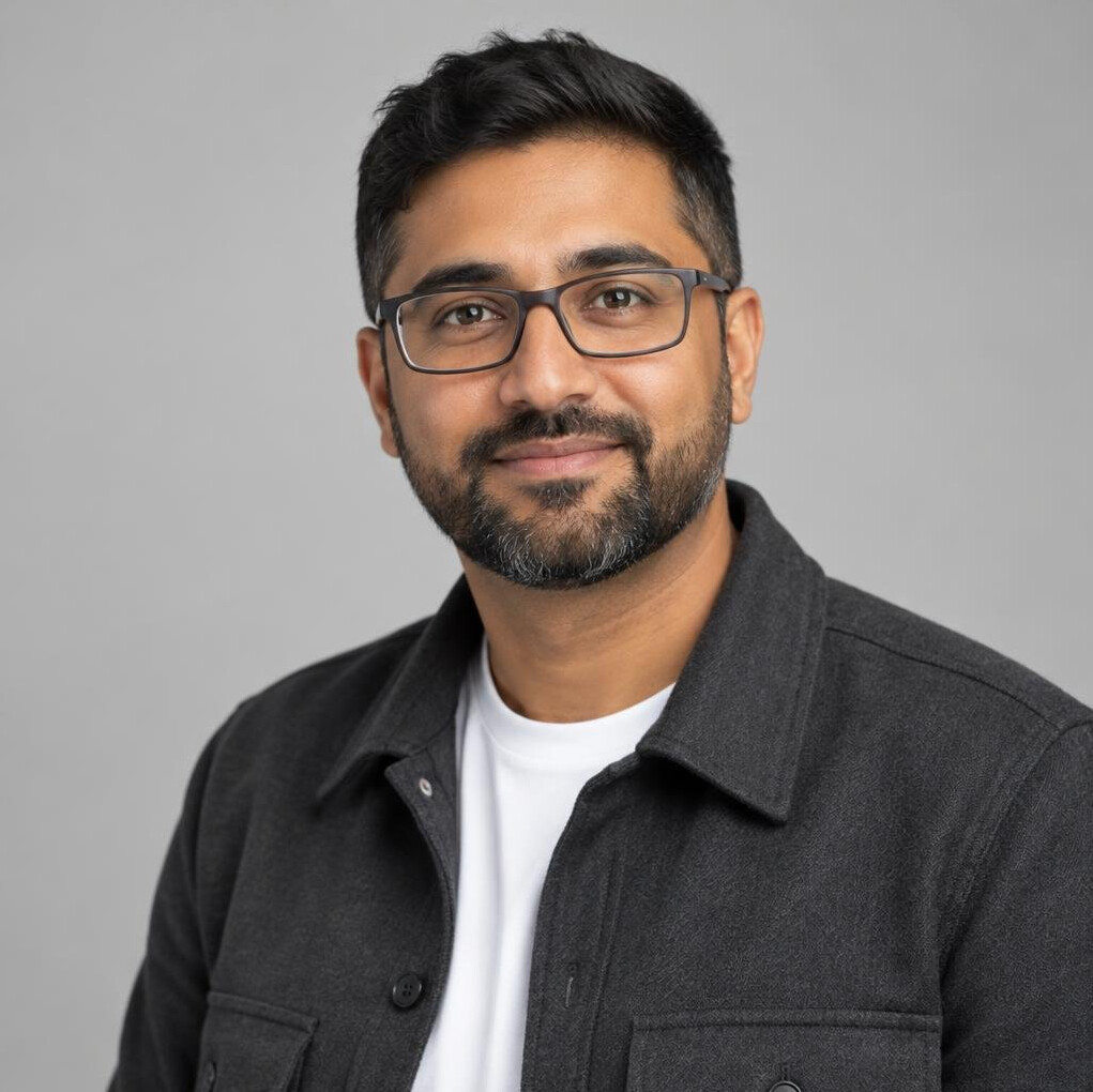 Portrait of a South Asian British man camera tutor with glasses